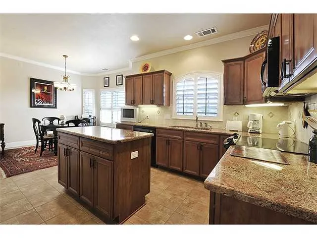 a view of a dining room with furniture and a chandelier