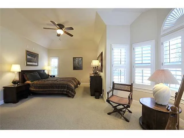 a bathroom with a granite countertop sink a large mirror and a shower