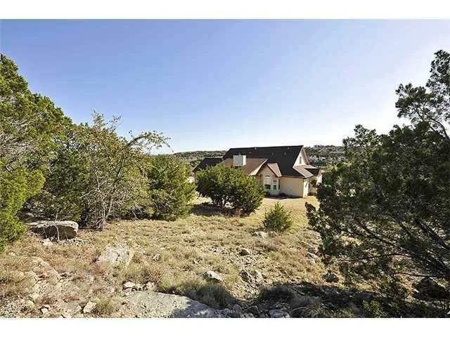 a view of a yard with a house in the background