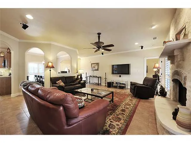 a view of a dining room and livingroom with furniture wooden floor a chandelier and a painting
