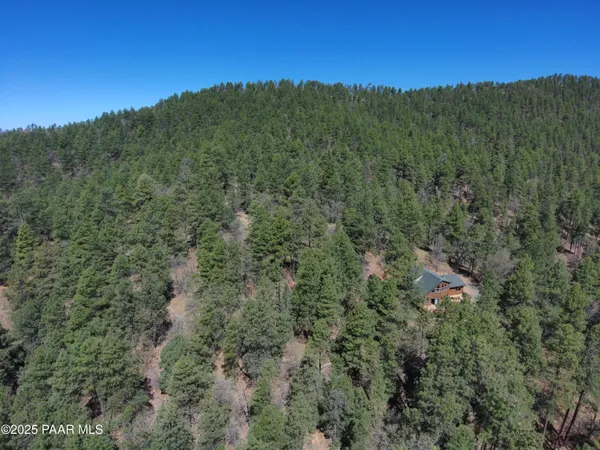 a view of a dining room with furniture a chandelier and wooden floor