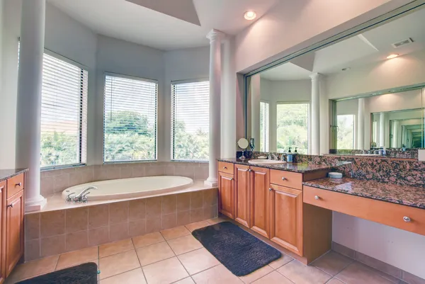 a large bathroom with a large tub and double vanity
