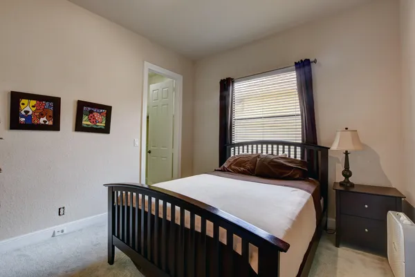a bedroom with a bed and a window