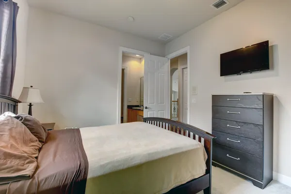 a bedroom with a bed and a flat screen tv