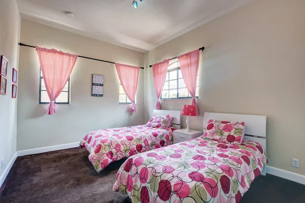 a bedroom with two beds and a window