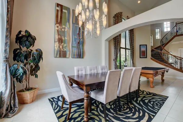 a dining room with furniture and wooden floor