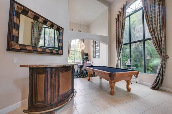a living room with furniture a large window and a fireplace
