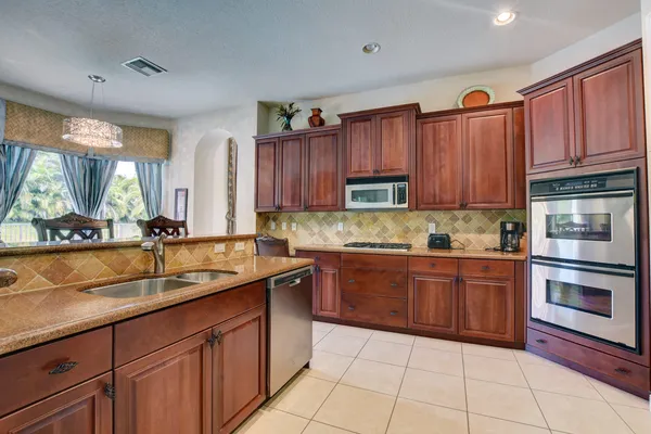 a kitchen with a sink stove and microwave