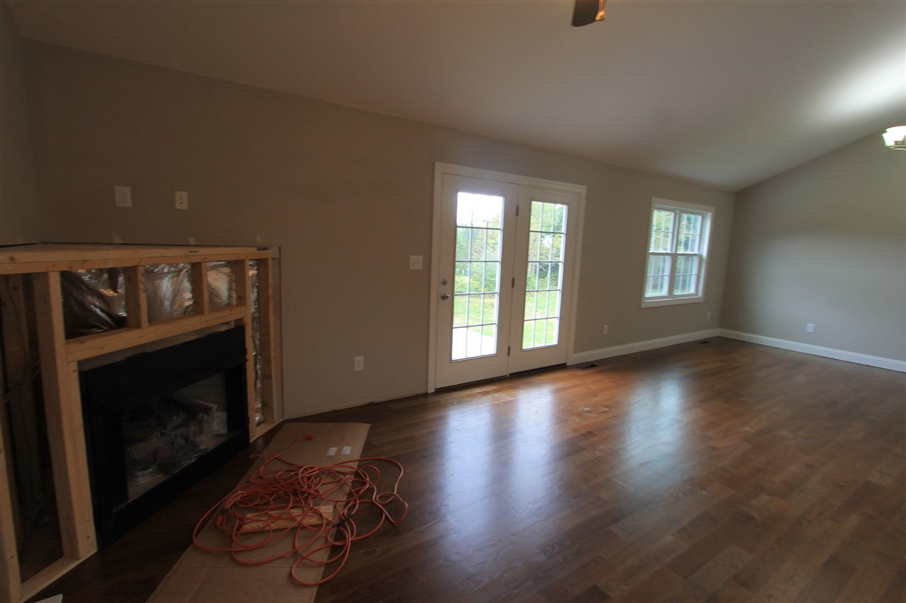 855 Battlefield Road Fort Defiance, VA 24437 - Photo 8 of 29 a view of an empty room with wooden floor fireplace and a window