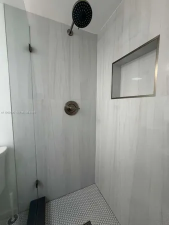 a bathroom with a shower and a sink