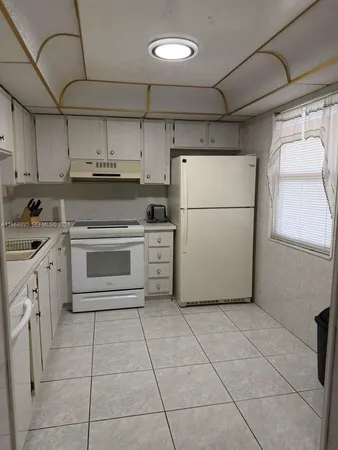 a kitchen with cabinets and appliances