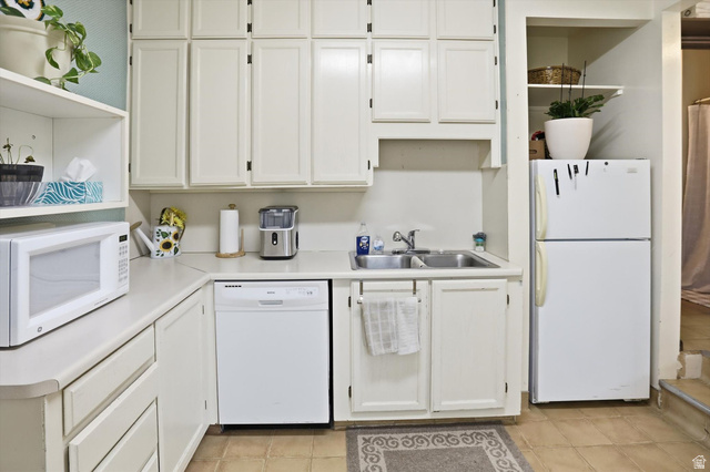 380 North 200 West Logan, UT 84321 - Photo 6 of 29 Kitchen featuring open shelves, white appliances, white cabinetry, light countertops, and light tile patterned floors