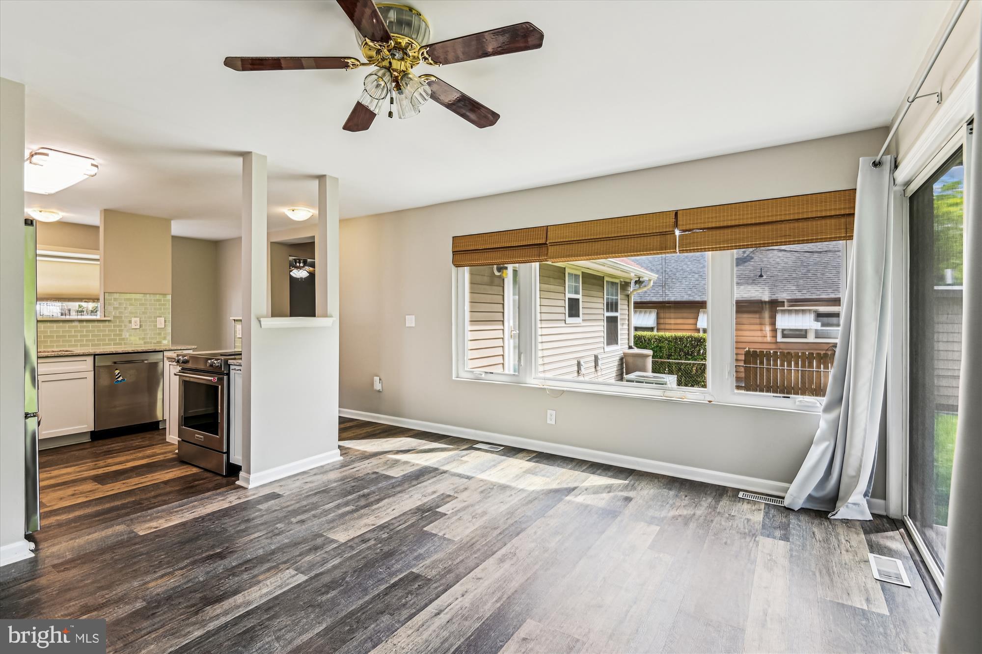 4012 Ramsey Drive Edgewater, MD 21037 - Photo 11 of 77 a view of an empty room with a window and wooden floor