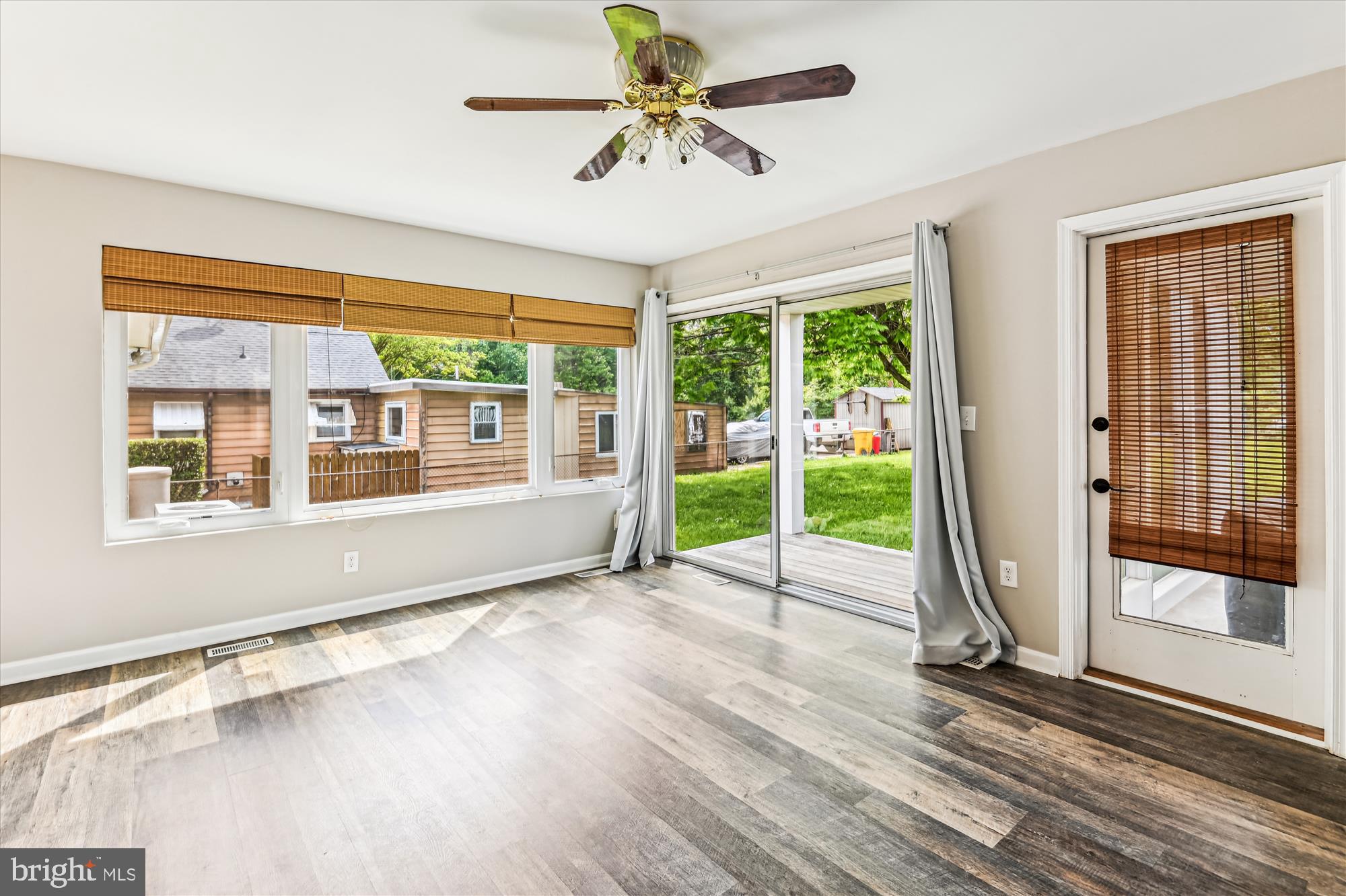 4012 Ramsey Drive Edgewater, MD 21037 - Photo 8 of 77 a view of an room with wooden floor a ceiling fan and windows
