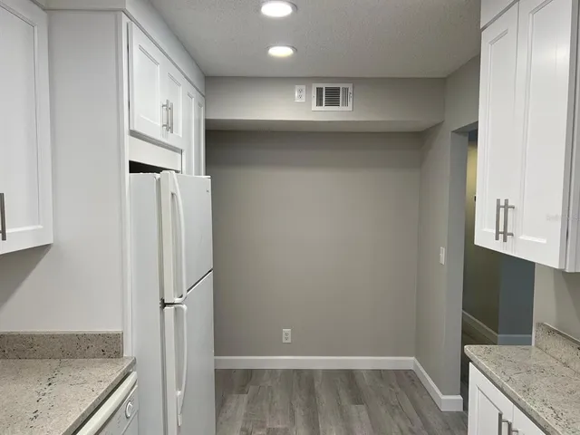 a view of a kitchen cabinets and wooden floor