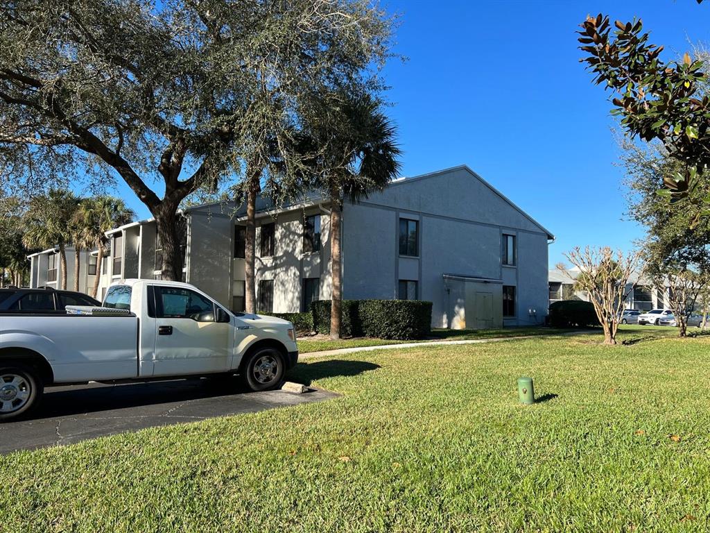1324 South Pine Ridge Circle, Unit D2 Sanford, FL 32773 - Photo 3 of 15 a view of a car parked in front of a house