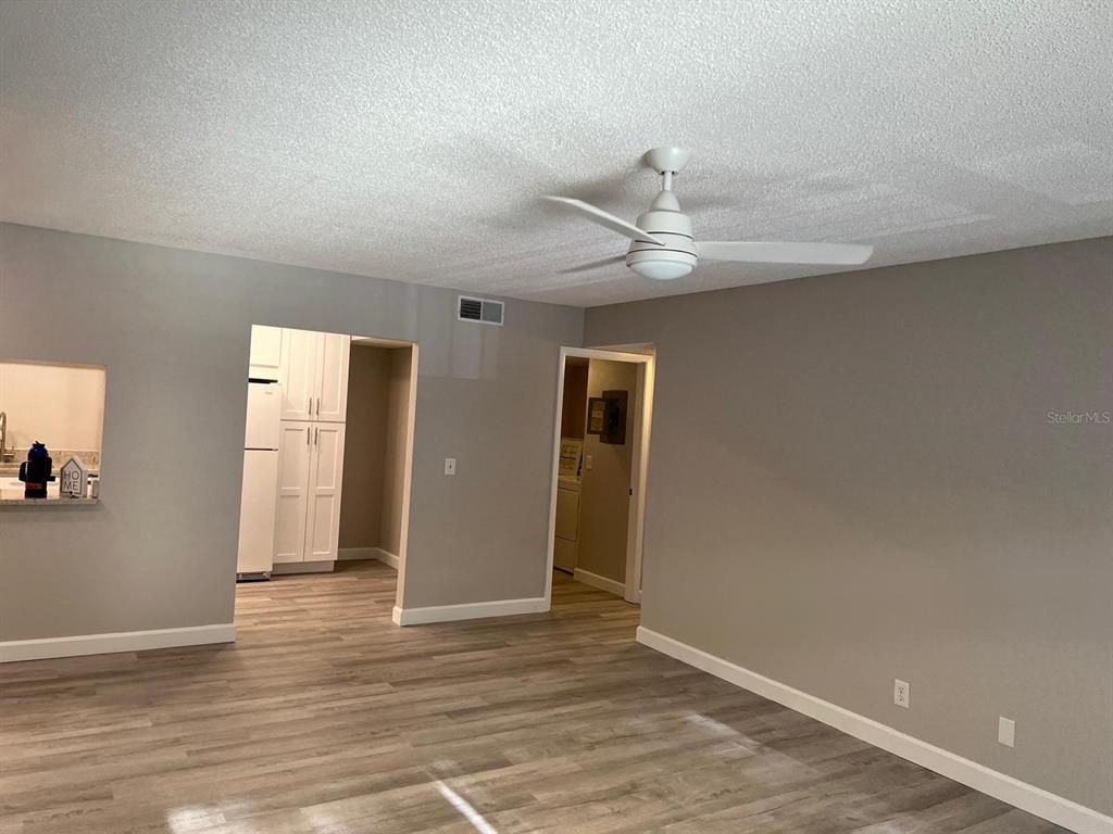 1324 South Pine Ridge Circle, Unit D2 Sanford, FL 32773 - Photo 6 of 15 an empty room with wooden floor and ceiling fan