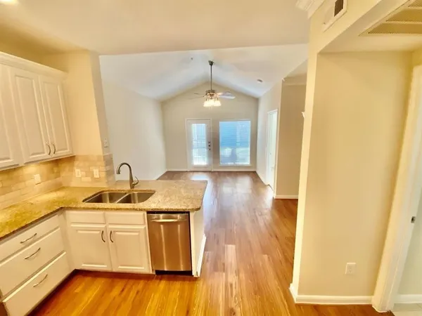 a kitchen with a sink and cabinets