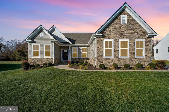 a front view of a house with a yard and porch