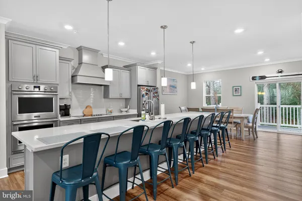 a large kitchen with a table and chairs