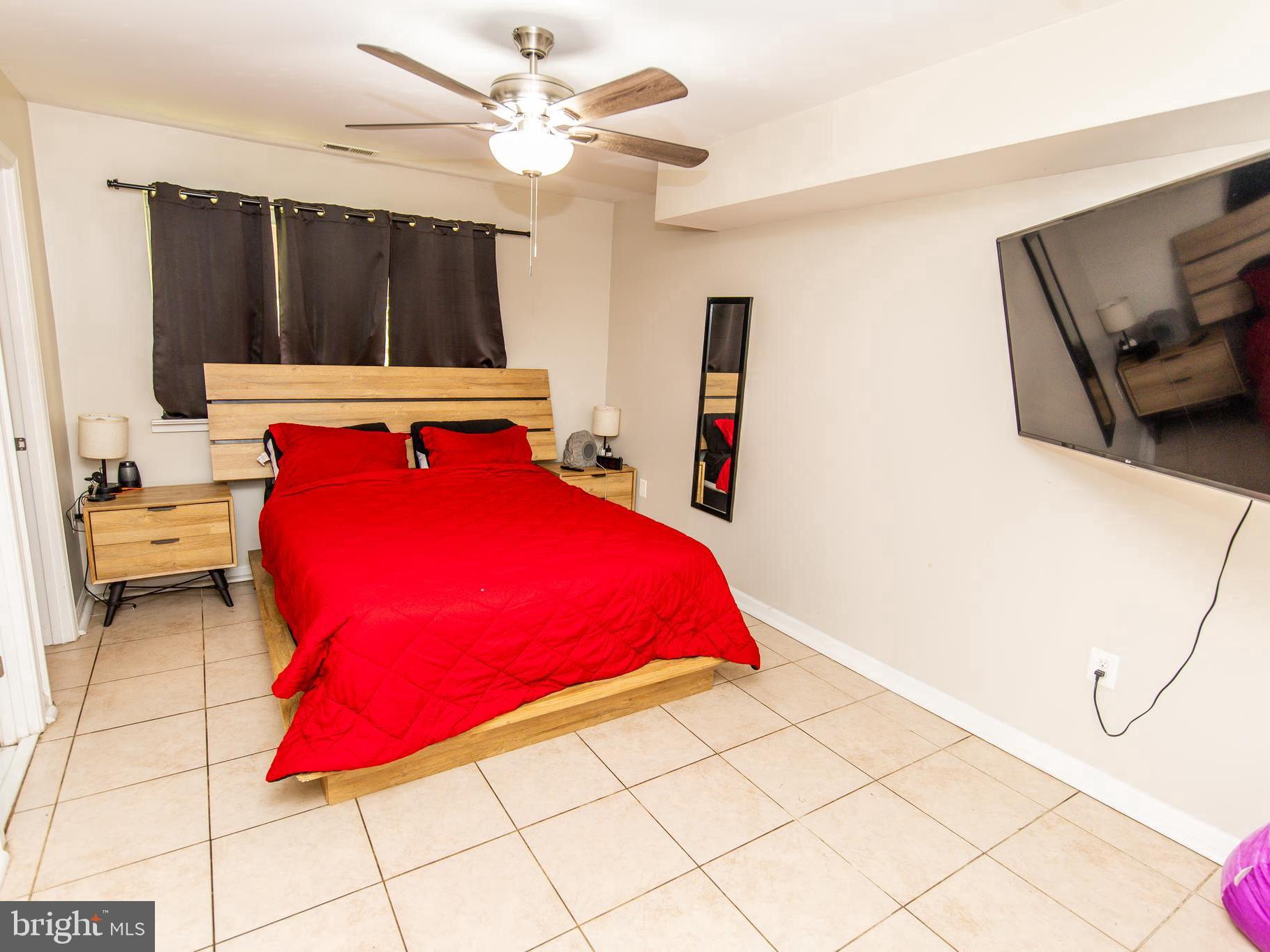 3934 Bel Pre Road, Unit 39342 Silver Spring, MD 20906 - Photo 18 of 30 a bedroom with a bed and a large mirror