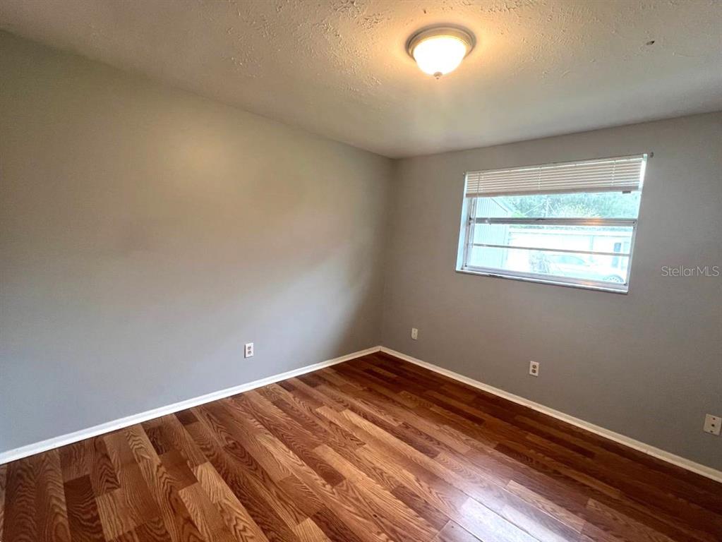 9406 Eastfield Road, Unit C Thonotosassa, FL 33592 - Photo 13 of 16 an empty room with a window