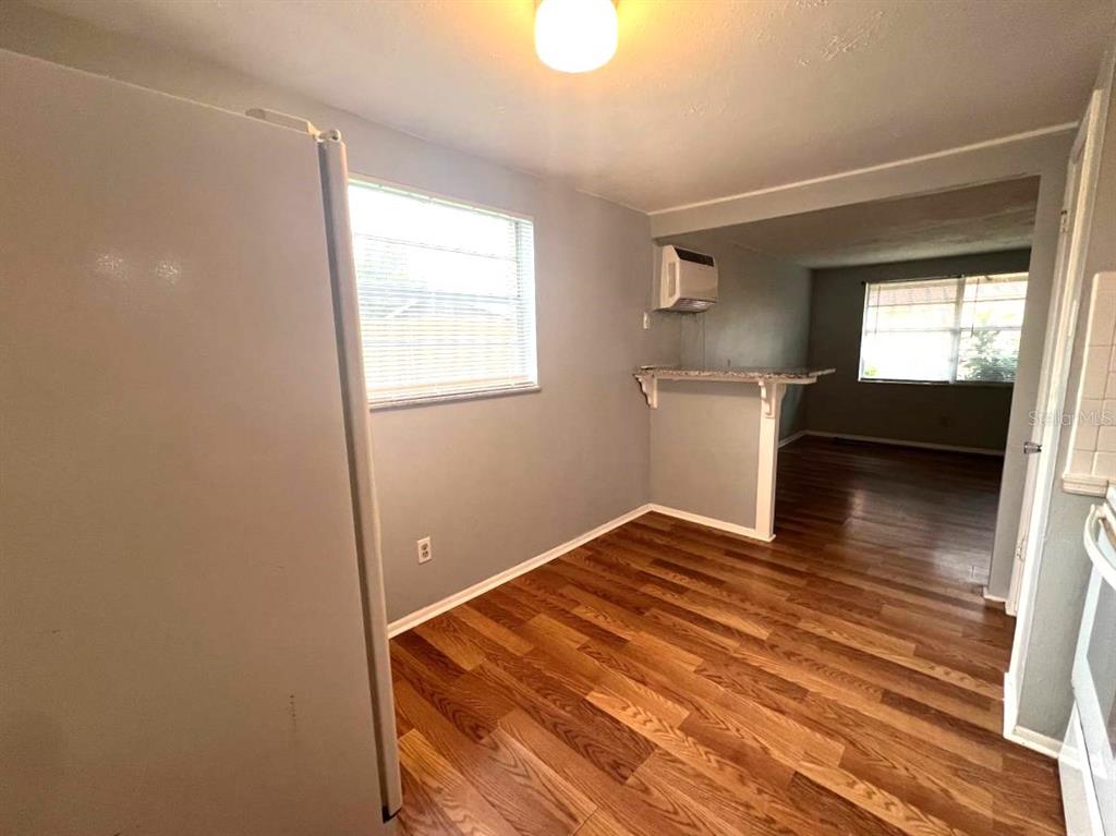 9406 Eastfield Road, Unit C Thonotosassa, FL 33592 - Photo 8 of 16 a view of empty room with wooden floor and fan