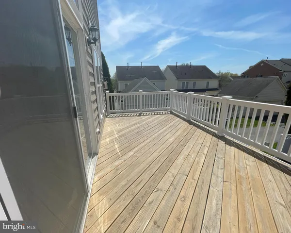 a view of balcony with wooden floor and fence