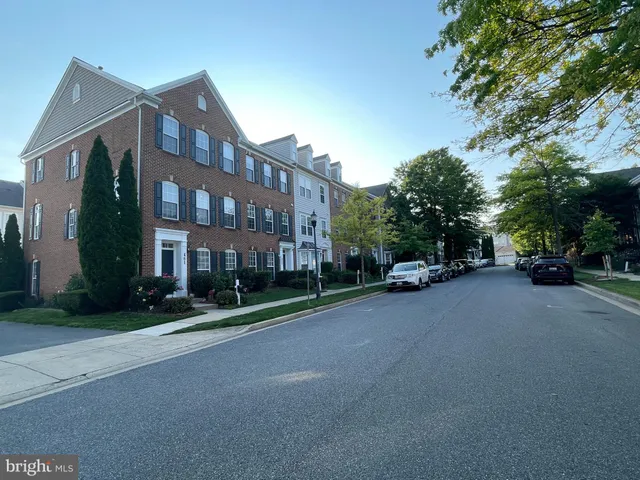a city street lined with buildings and trees