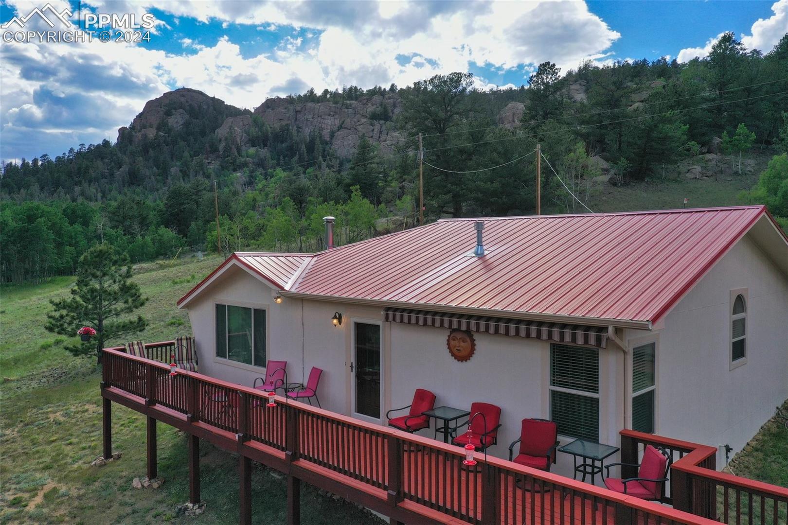 35 Cree Path Lake George, CO 80827 - Photo 1 of 46 Rear view of property with a wooden deck and a yard