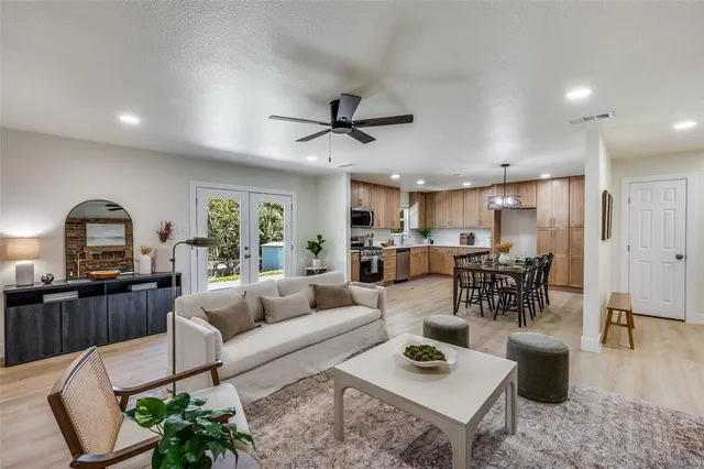 a living room with furniture and kitchen view
