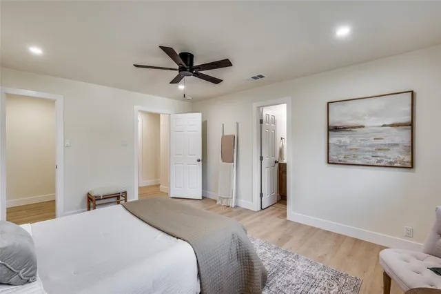 a bedroom with a large bed and a painting