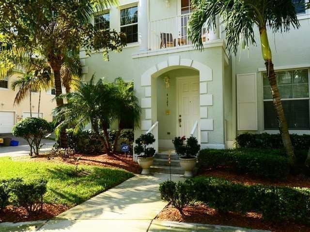 4127 Sandy Spit Lane Jupiter, FL 33458 - Photo 1 of 24 a front view of a house with garden