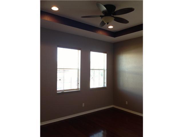 4127 Sandy Spit Lane Jupiter, FL 33458 - Photo 13 of 24 a room with windows and a ceiling fan
