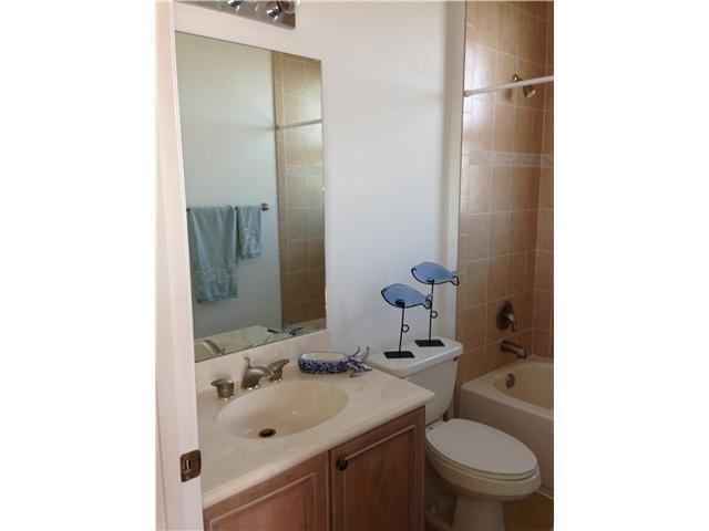 4127 Sandy Spit Lane Jupiter, FL 33458 - Photo 15 of 24 a bathroom with a sink toilet and mirror
