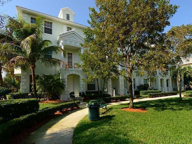 4127 Sandy Spit Lane Jupiter, FL 33458 - Photo 2 of 24 a front view of a house with garden and trees
