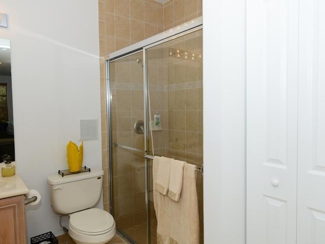 4127 Sandy Spit Lane Jupiter, FL 33458 - Photo 6 of 24 a white toilet sitting next to a bathroom sink