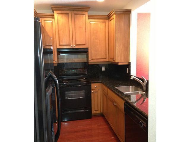 4127 Sandy Spit Lane Jupiter, FL 33458 - Photo 8 of 24 a kitchen with granite countertop a stove and a microwave