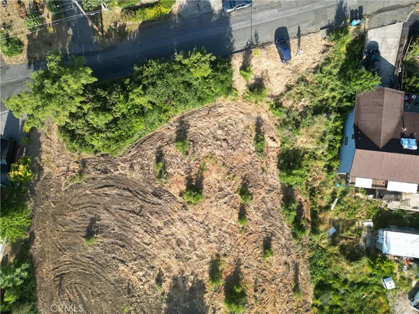 a group of tables and chairs under an umbrella in front of a building
