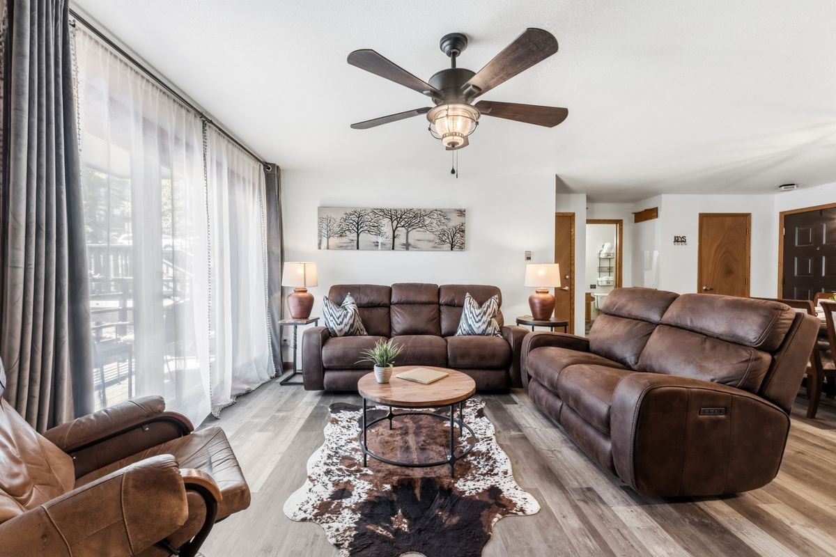 89410 Ryan Gulch Road, Unit 208 Silverthorne, CO 80498 - Photo 2 of 30 a living room with furniture and a large window
