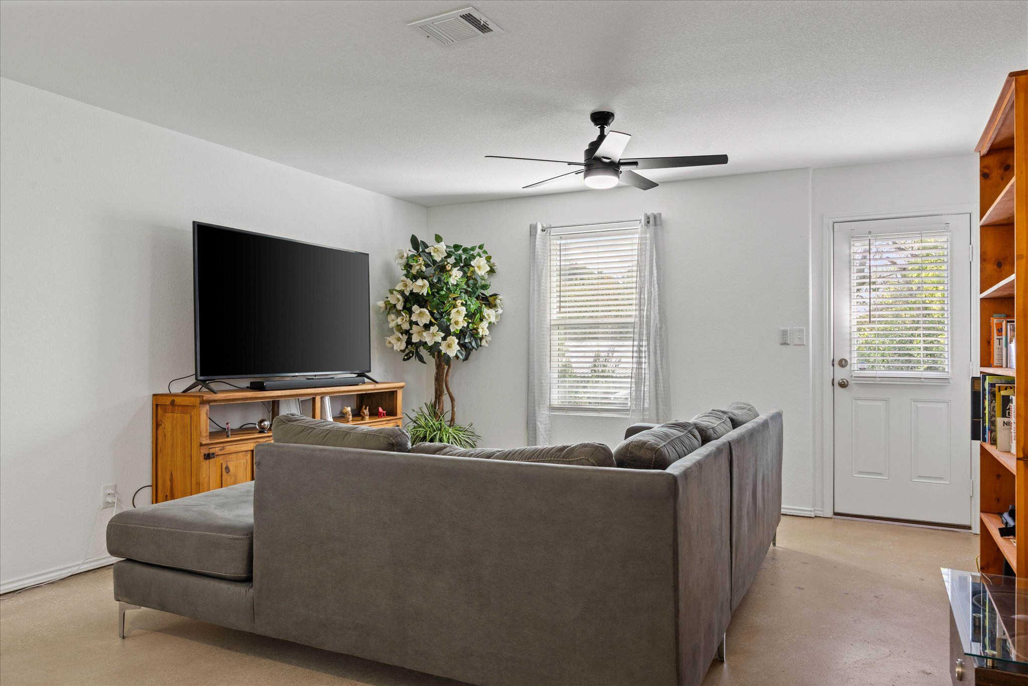 36 Trinity Circle Lockhart, TX 78644 - Photo 8 of 24 Smooth concrete floors and ample natural light define this versatile living area.