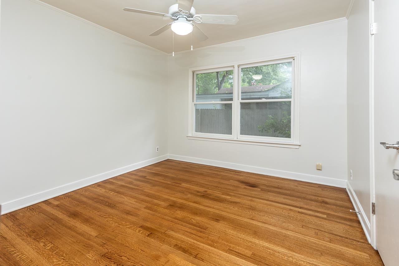 1004 South Perkins Road Memphis, TN 38117 - Photo 11 of 19 an empty room with wooden floor fan and windows