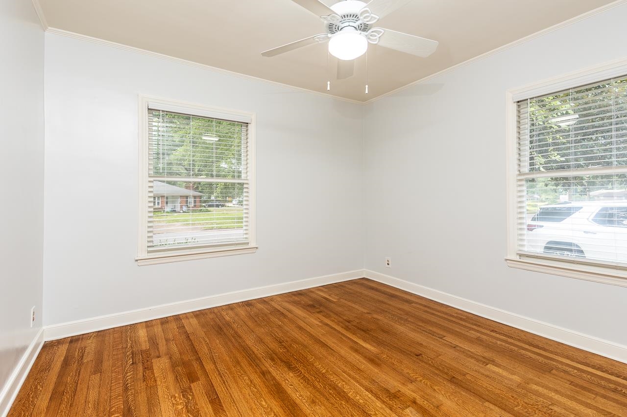 1004 South Perkins Road Memphis, TN 38117 - Photo 10 of 19 wooden floor in an empty room with a window