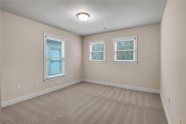 a front view of a building with a garden