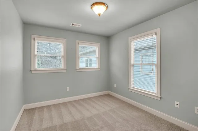a large bathroom with a large mirror vanity and a sink