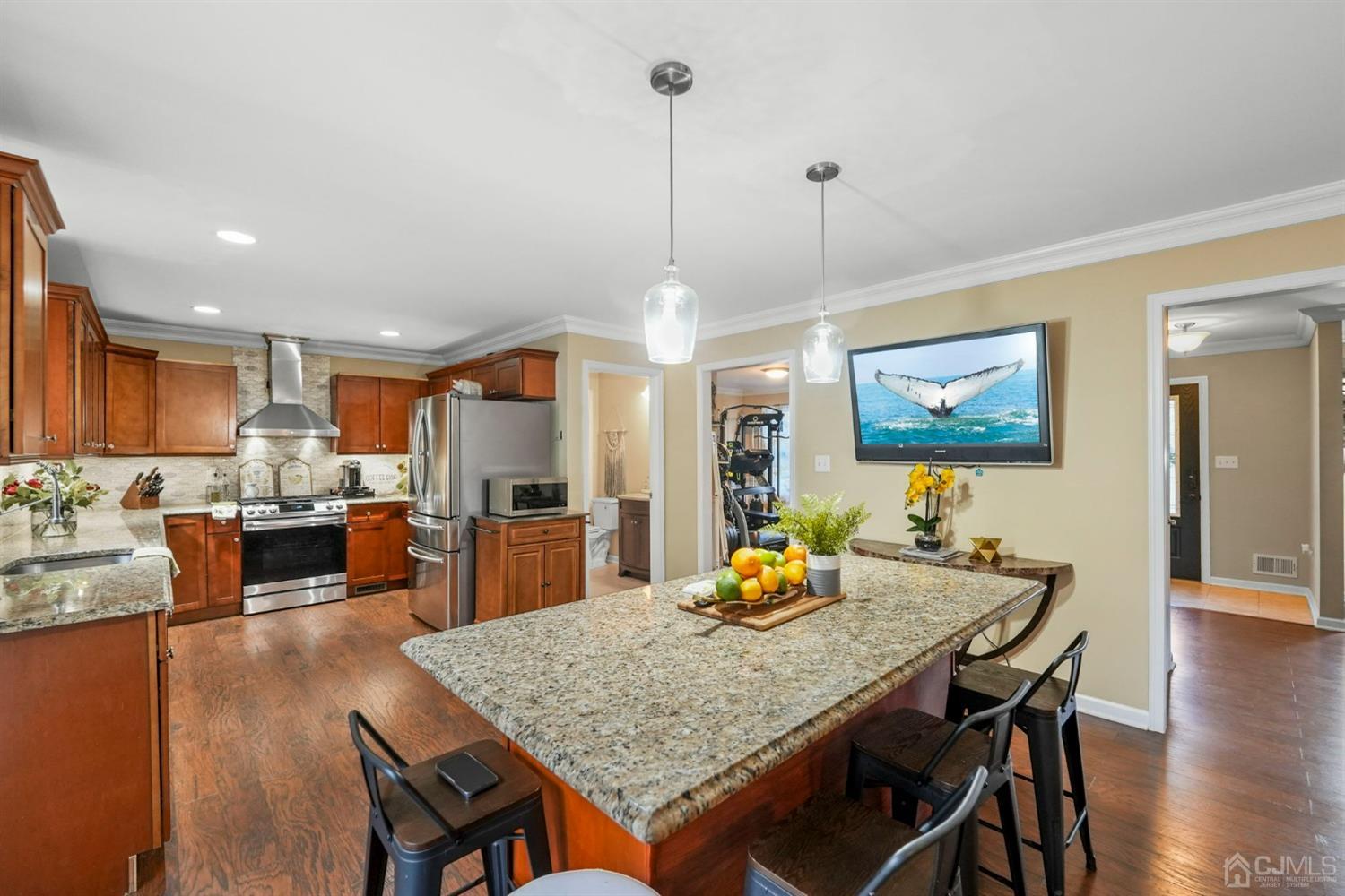 14 Baxter Road Edison, NJ 08817 - Photo 12 of 39 a view of a dining room and livingroom with furniture wooden floor a rug a painting and a chandelier