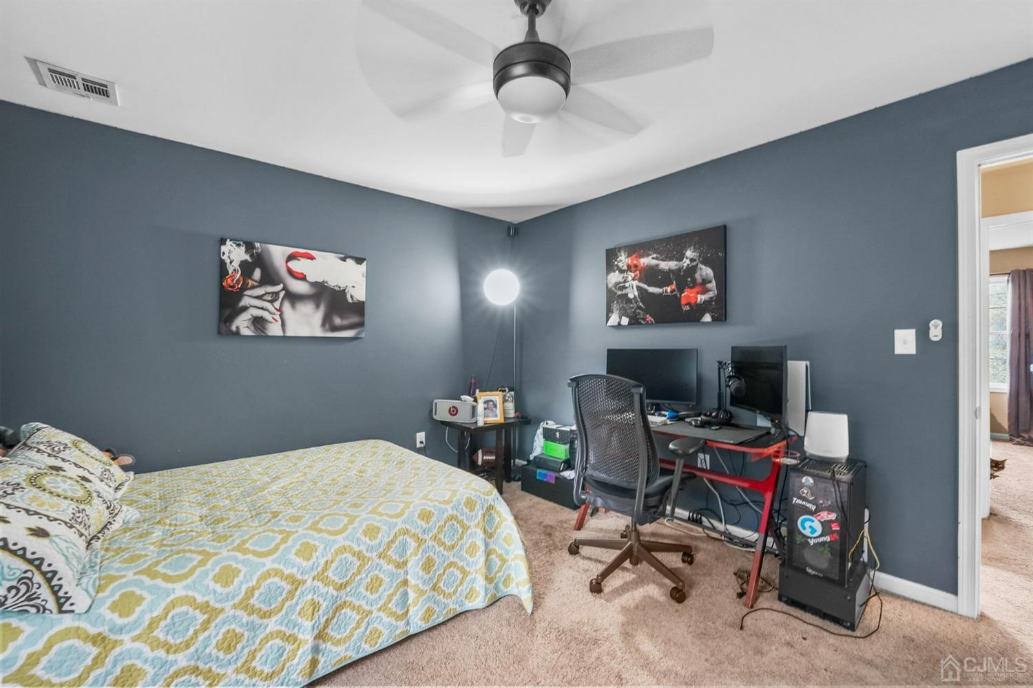14 Baxter Road Edison, NJ 08817 - Photo 25 of 39 a bedroom with bed a desk and a chandelier