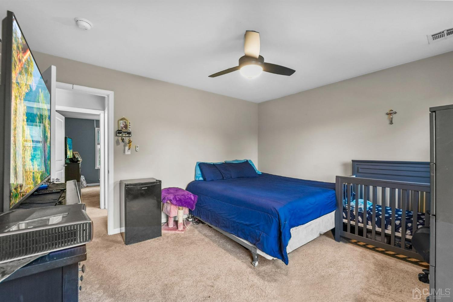 14 Baxter Road Edison, NJ 08817 - Photo 27 of 39 a bedroom with a bed and a chandelier
