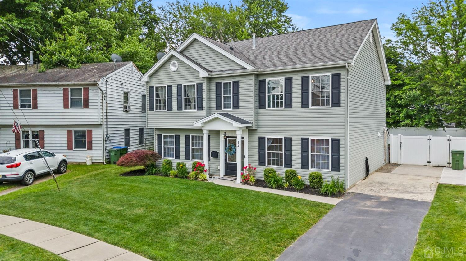 14 Baxter Road Edison, NJ 08817 - Photo 3 of 39 a front view of a house with a garden and plants
