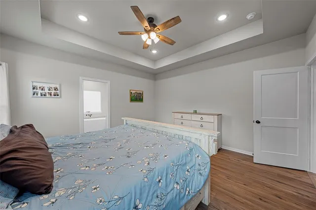 a living room with a bed furniture and a ceiling fan